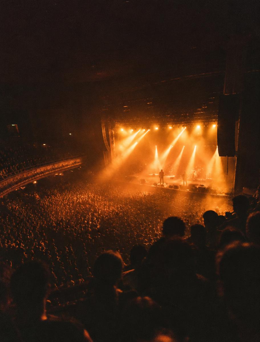 A Motion Crü production — packed venue under amber stage light